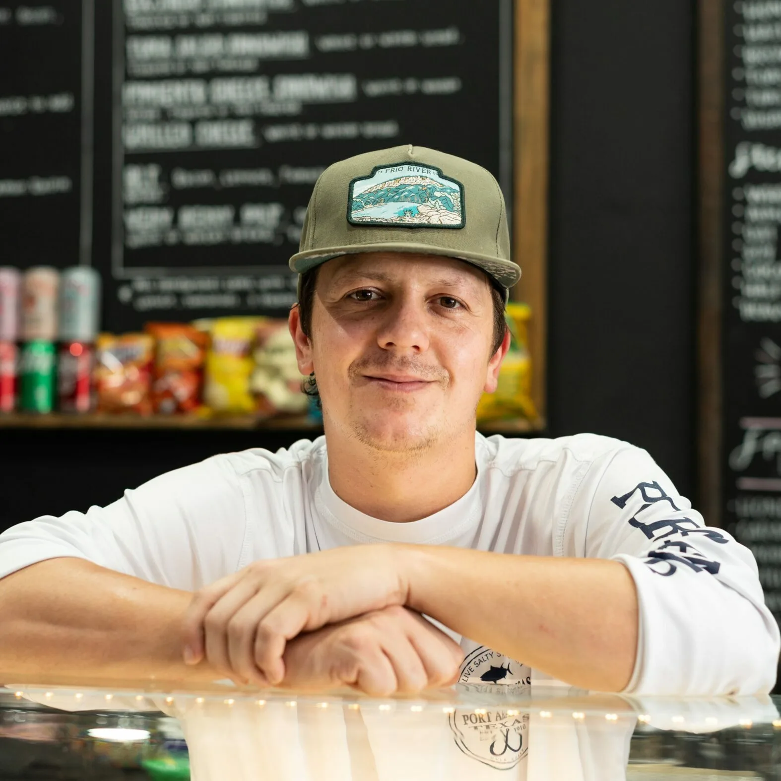 Owner leaning on the counter at Farmhouse Coffee & Cream